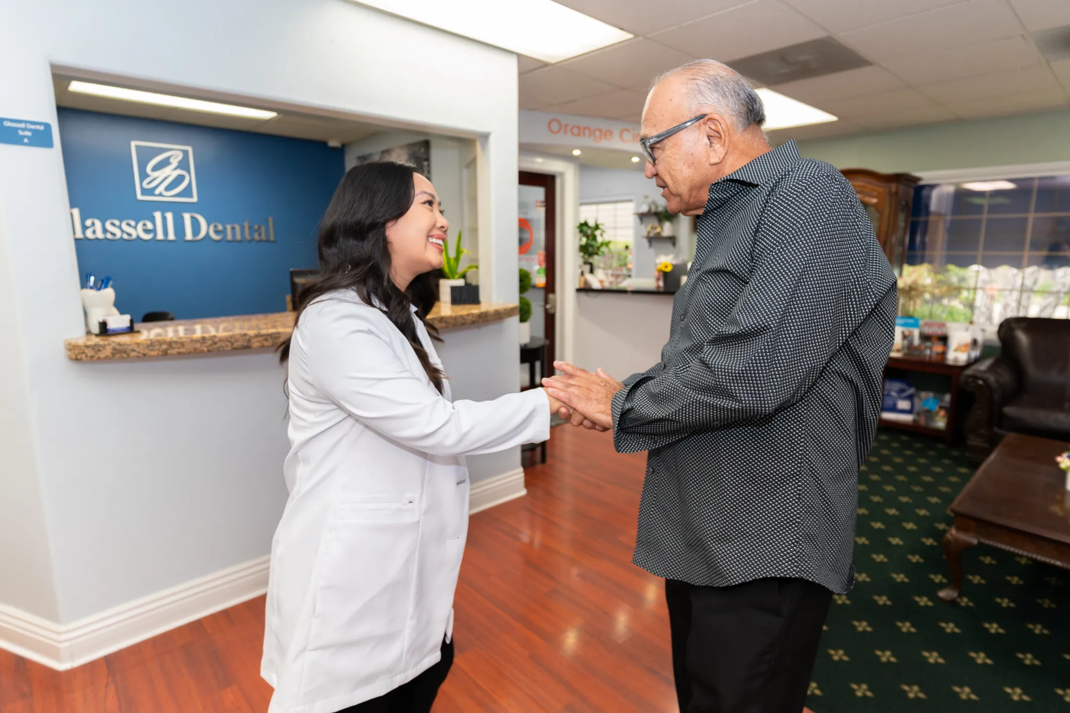 Dr. Marilyn Nguyen greeting a patient in the Glassell Dental lobby